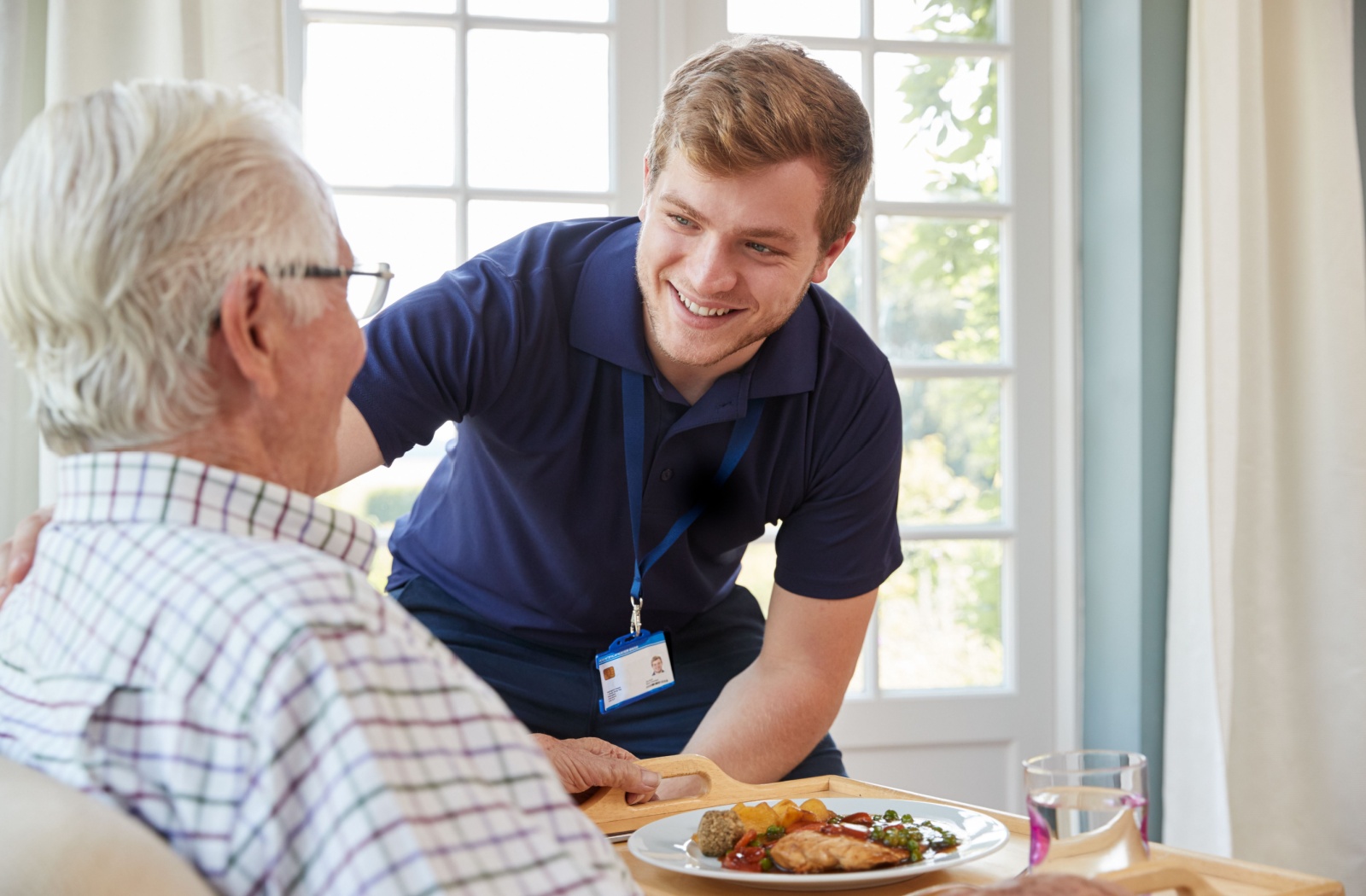 A skilled nurse checking in on a senior man.