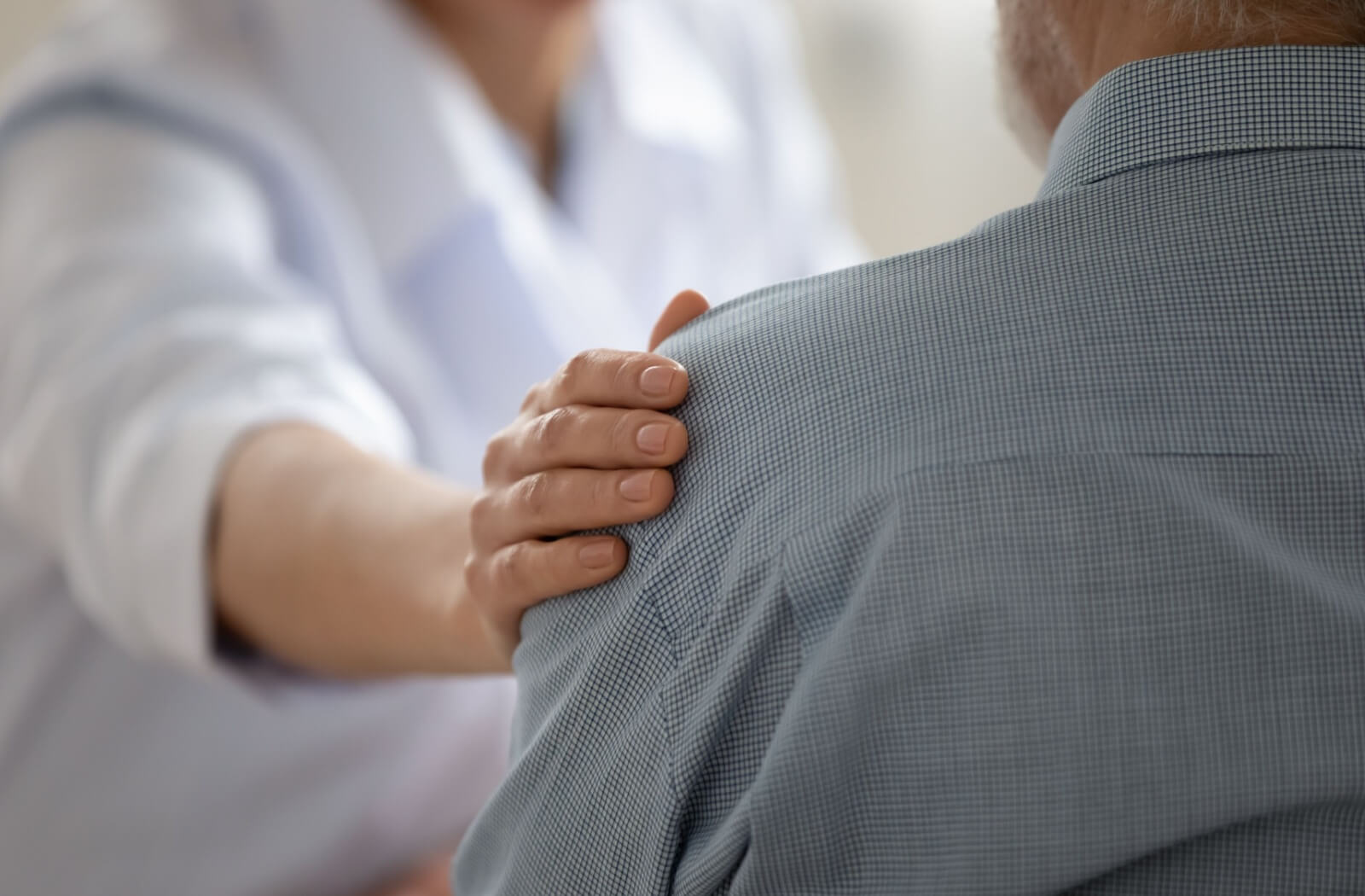 a caregiver comforting a senior in senior living