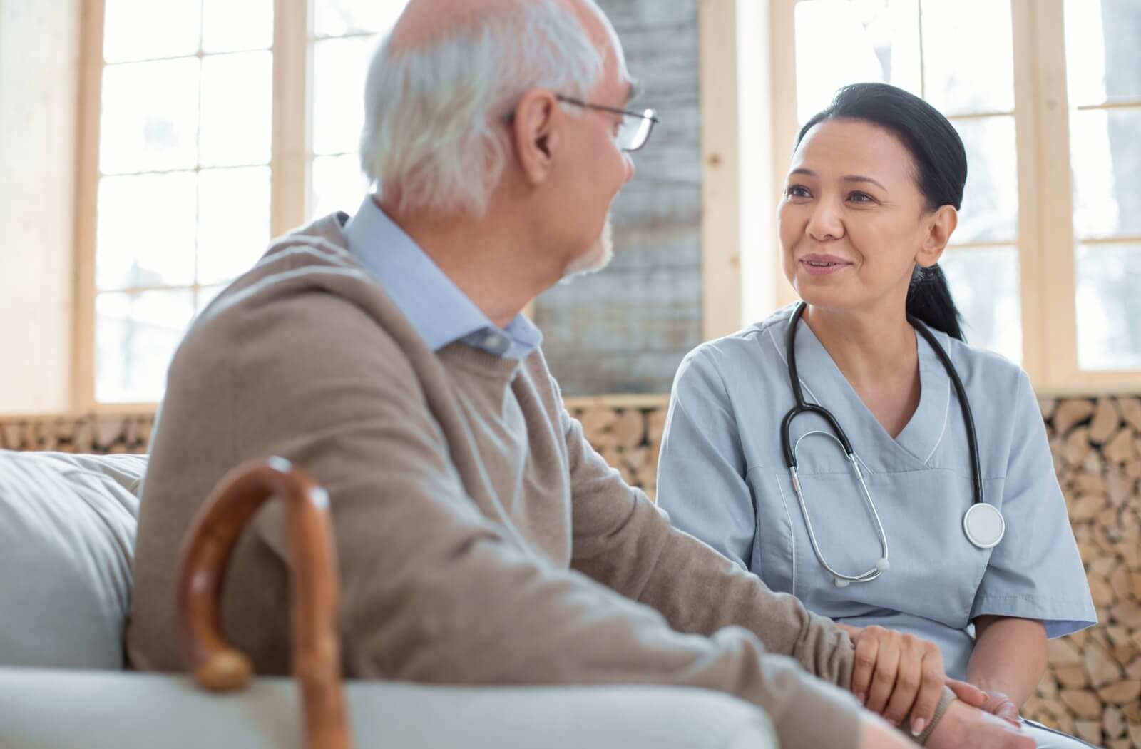 An older adult sits with a caregiver to learn more about what skilled nursing can offer.